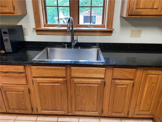 a kitchen with a sink cabinets and a window