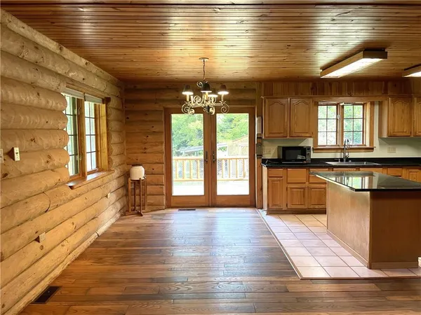 a large kitchen with granite countertop a stove a sink and a refrigerator