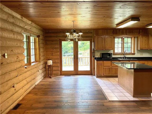 a large kitchen with granite countertop a stove a sink and a refrigerator