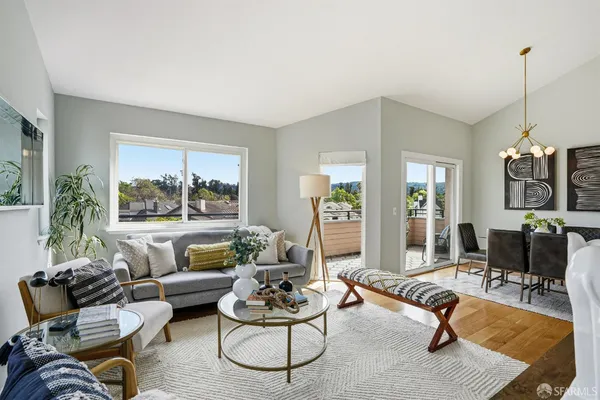 a living room with furniture rug and window