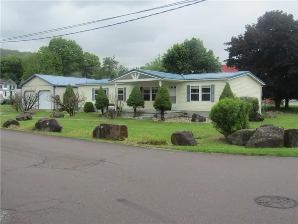 a front view of a house with a yard and porch