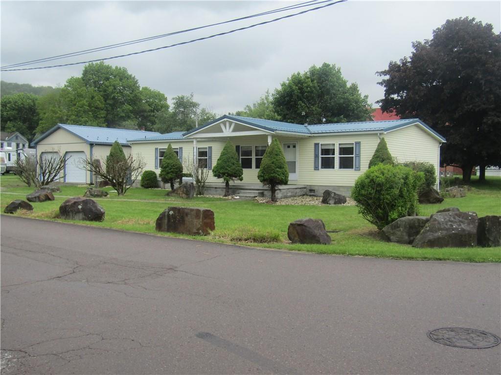 a front view of a house with a yard and porch