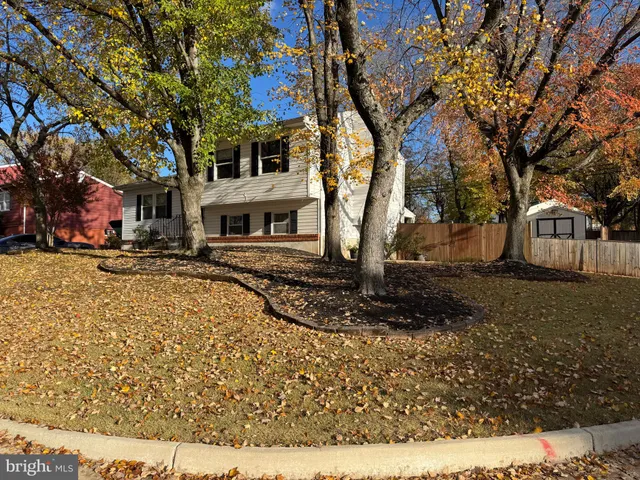 a view of a white house with a yard covered in snow