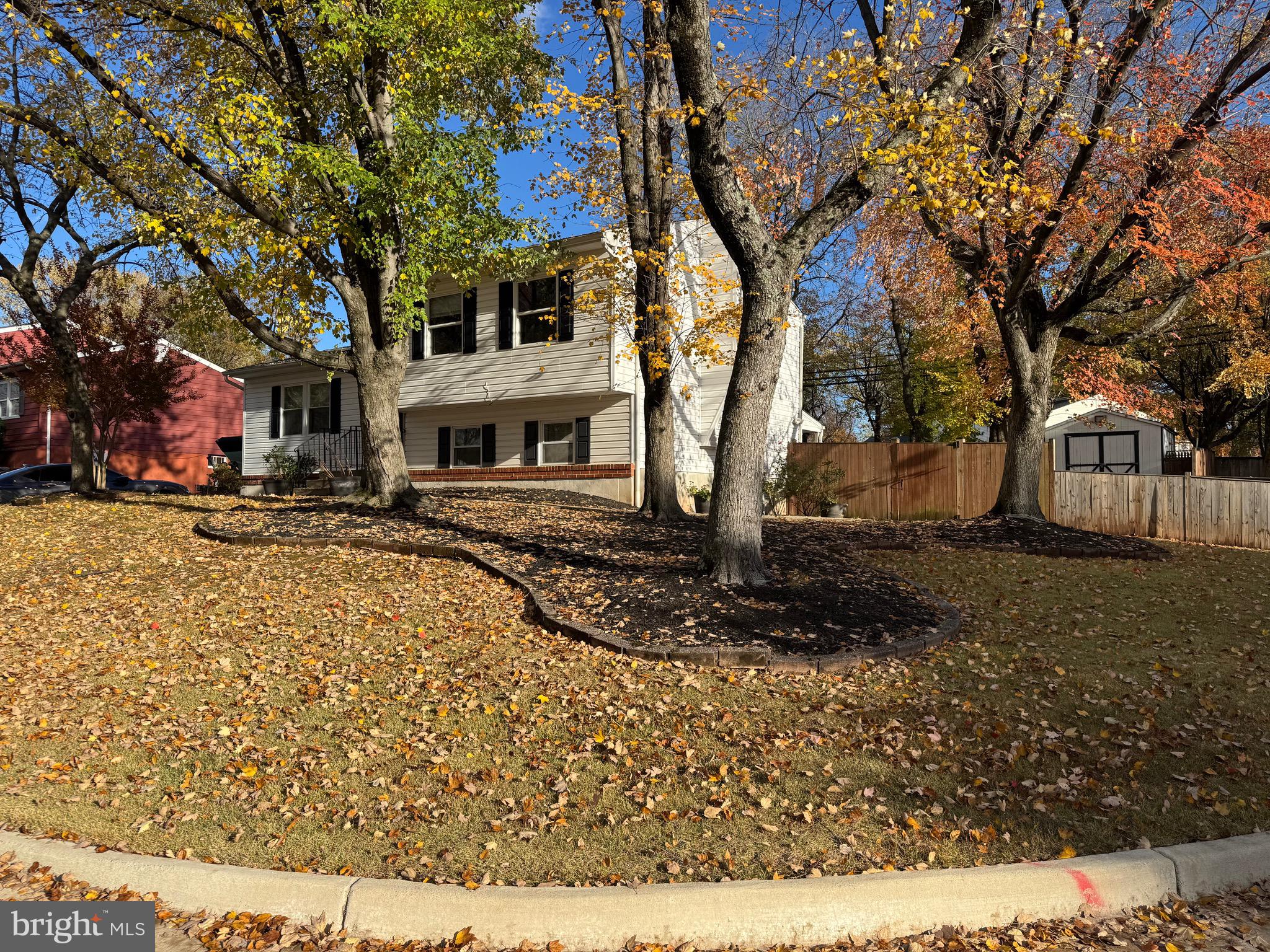 9215 Landgreen Street Manassas, VA 20110 - Photo 2 of 18 a view of a white house with a yard covered in snow