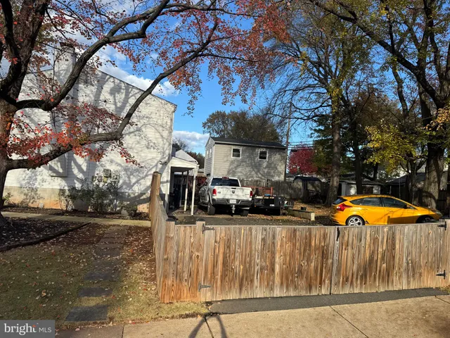 a view of a house with a yard covered trees in a patio