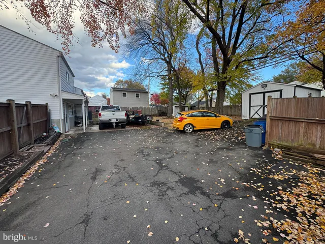 a backyard of a house with barbeque oven a table and chairs