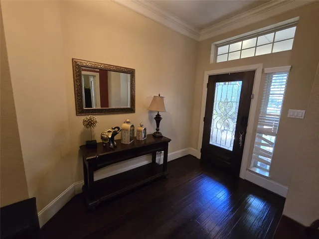 a dining room with furniture a chandelier and wooden floor