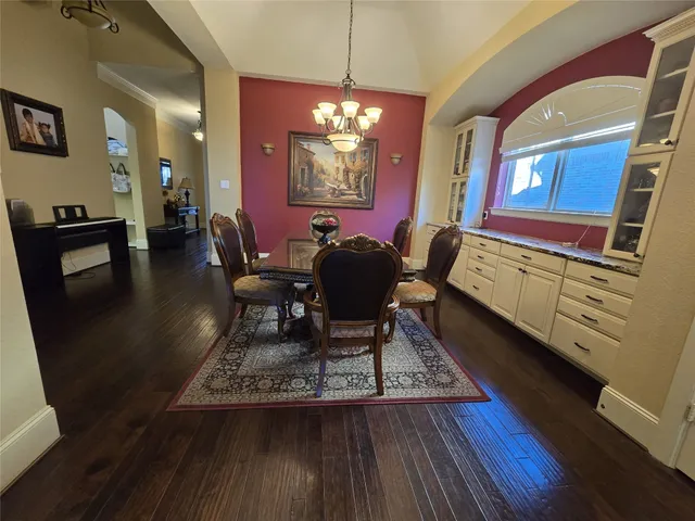 a kitchen with stainless steel appliances granite countertop a refrigerator a stove top oven a sink dishwasher and wooden cabinets