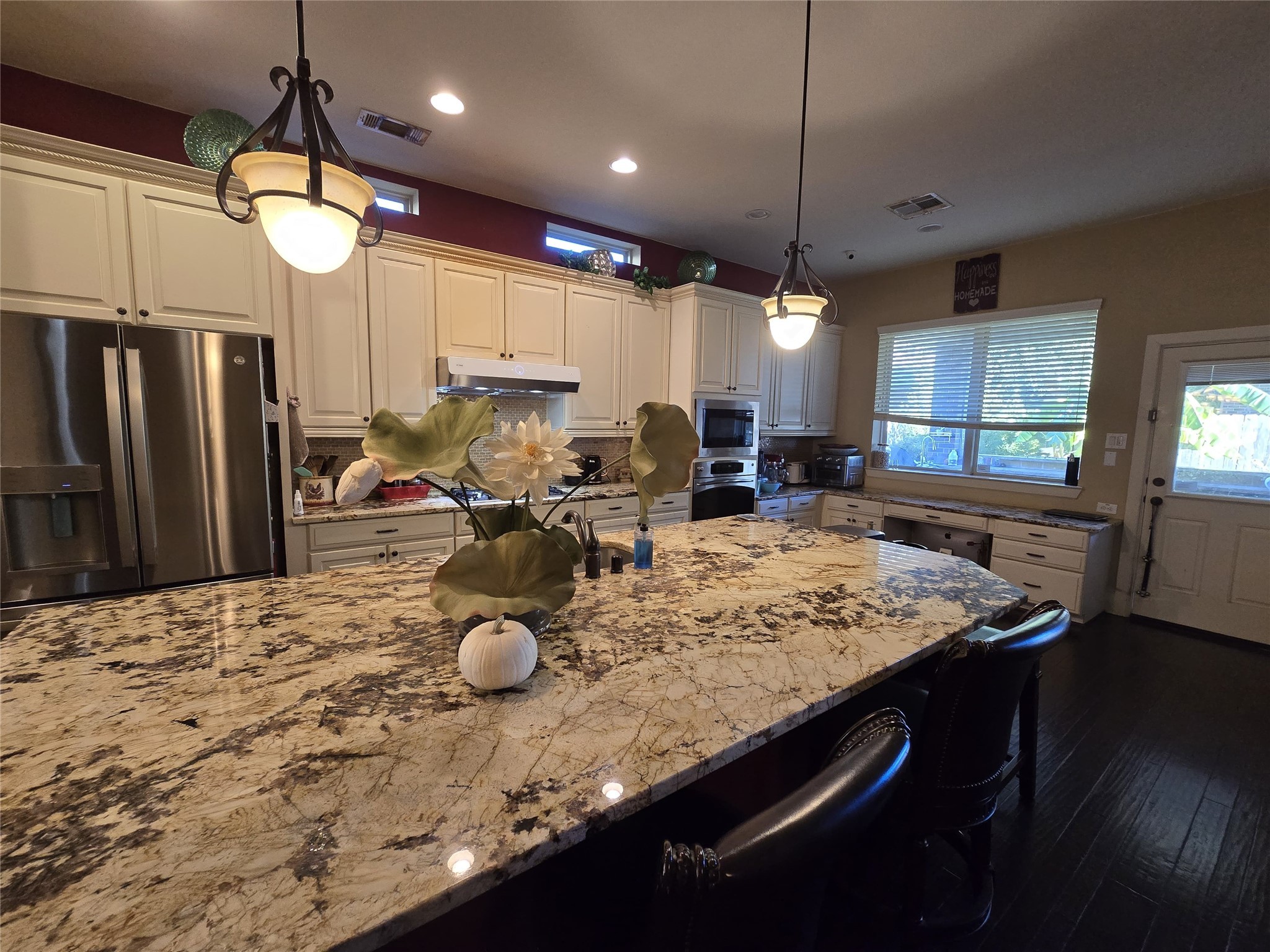 4815 Ashley Hope Drive Katy, TX 77494 - Photo 14 of 26 a kitchen with sink refrigerator dining table and chairs