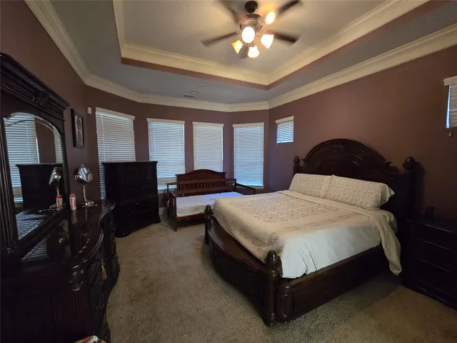 a living room with dining area furniture a chandelier and a fireplace