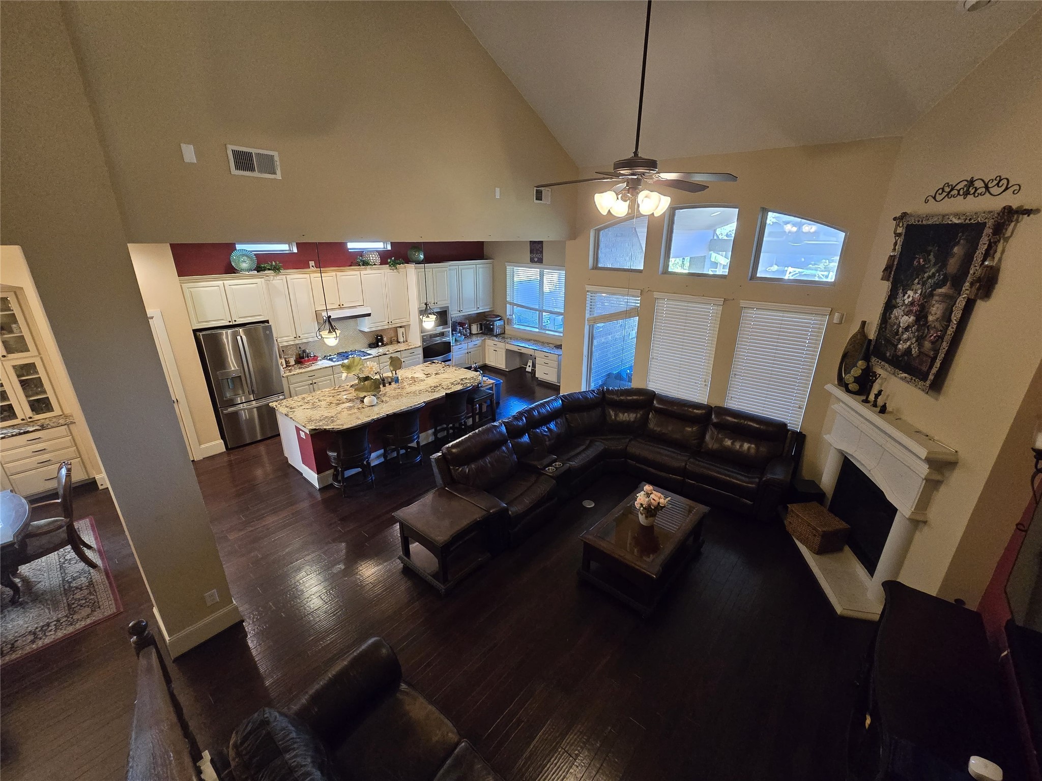 4815 Ashley Hope Drive Katy, TX 77494 - Photo 18 of 26 a living room with dining area furniture a chandelier and a fireplace