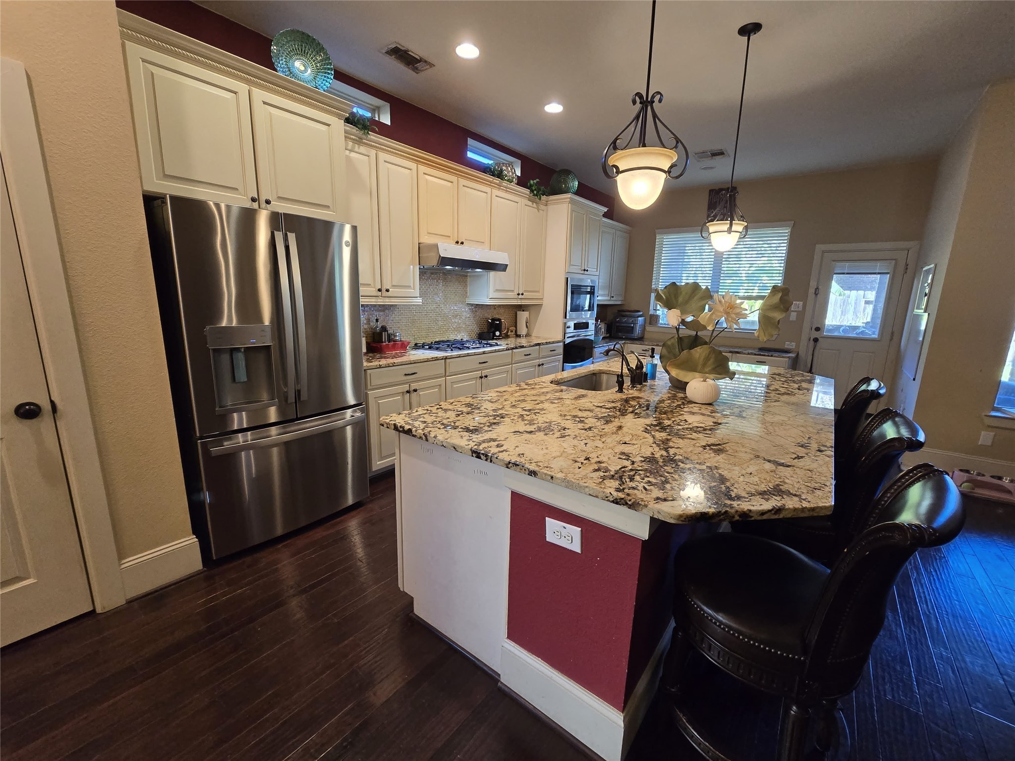 4815 Ashley Hope Drive Katy, TX 77494 - Photo 20 of 26 a kitchen with stainless steel appliances granite countertop a refrigerator a stove a sink dishwasher a refrigerator white cabinets and wooden floor