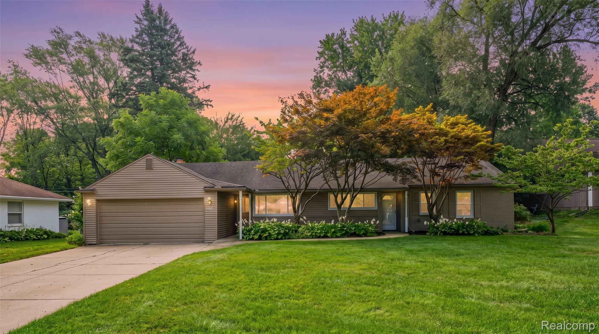 2329 Rutherford Road Bloomfield Hills, MI 48302 - Photo 2 of 46 Single-story residence featuring horizontal siding, an attached garage, a paved driveway, and established front landscaping