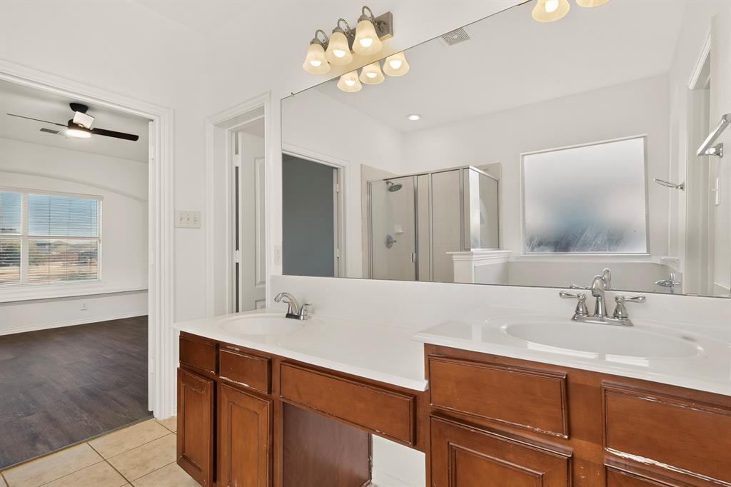 14908 Riverside Drive Little Elm, TX 75068 - Photo 24 of 40 Dual vanity with integrated sinks, wood-finish cabinetry, and chrome fixtures