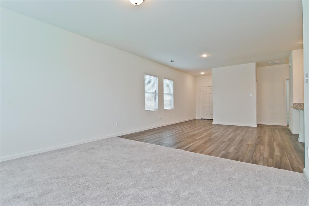 1637 Shadow Hawk Drive Fort Worth, TX 76052 - Photo 9 of 20 an empty room with wooden floor and window