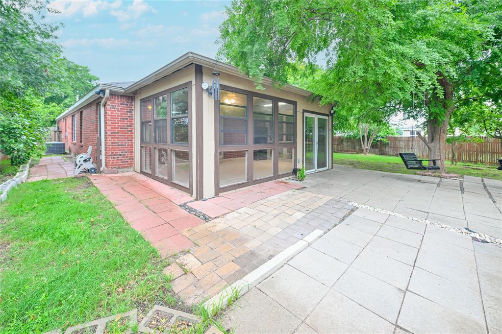 910 Rocking Spur Cove Pflugerville, TX 78660 - Photo 14 of 17 An inviting outdoor patio adjoins a charming sunroom, ideal for relaxation.