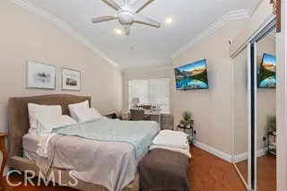 a bedroom with a bed and a chandelier