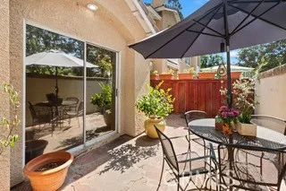 a patio with a patio table and chairs