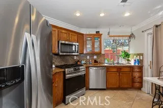 a kitchen with stainless steel appliances granite countertop a stove a sink and a refrigerator