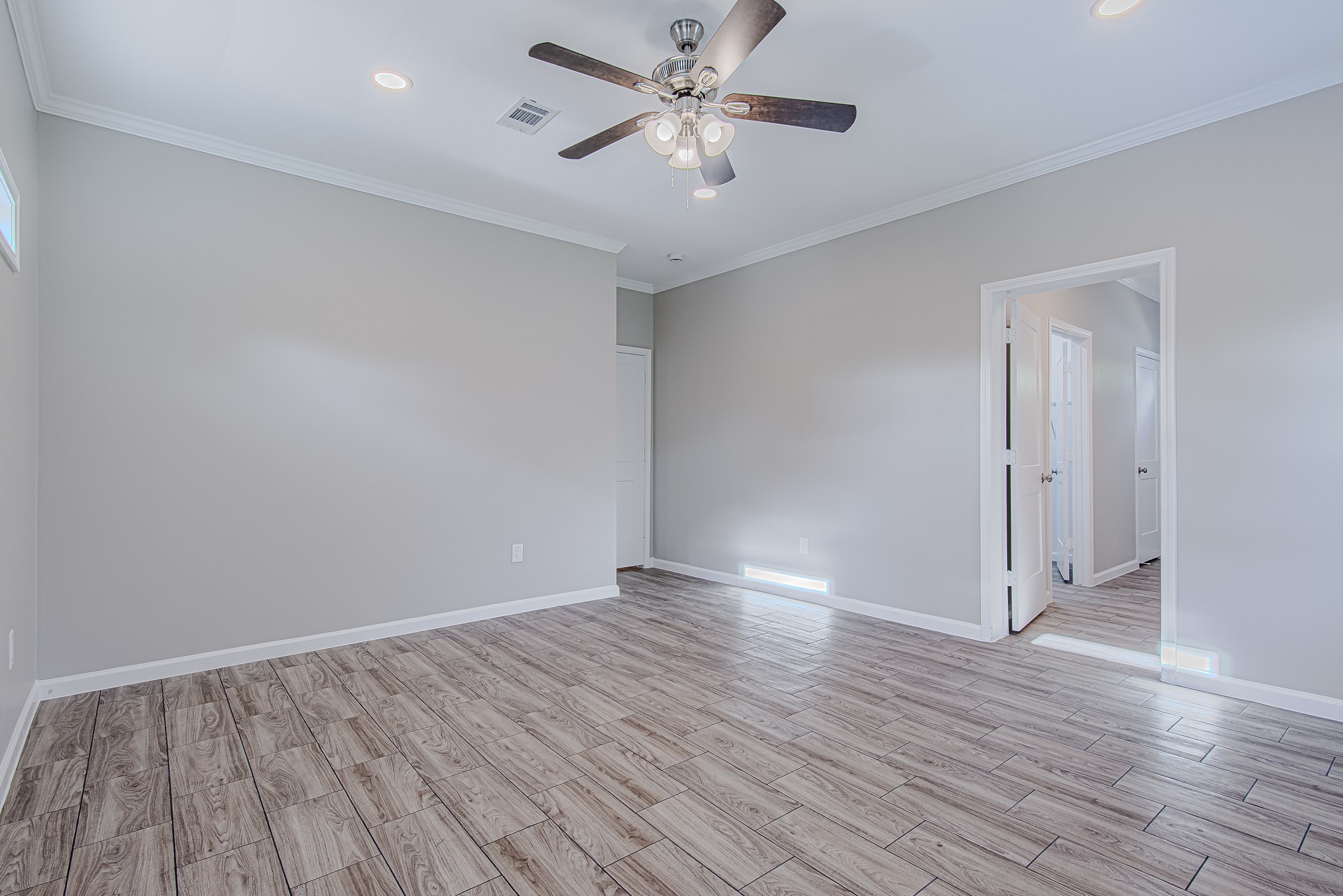 778 Pickering Street Houston, TX 77091 - Photo 14 of 26 Another angle of the primary suite showcasing its open layout and private access to the ensuite bath