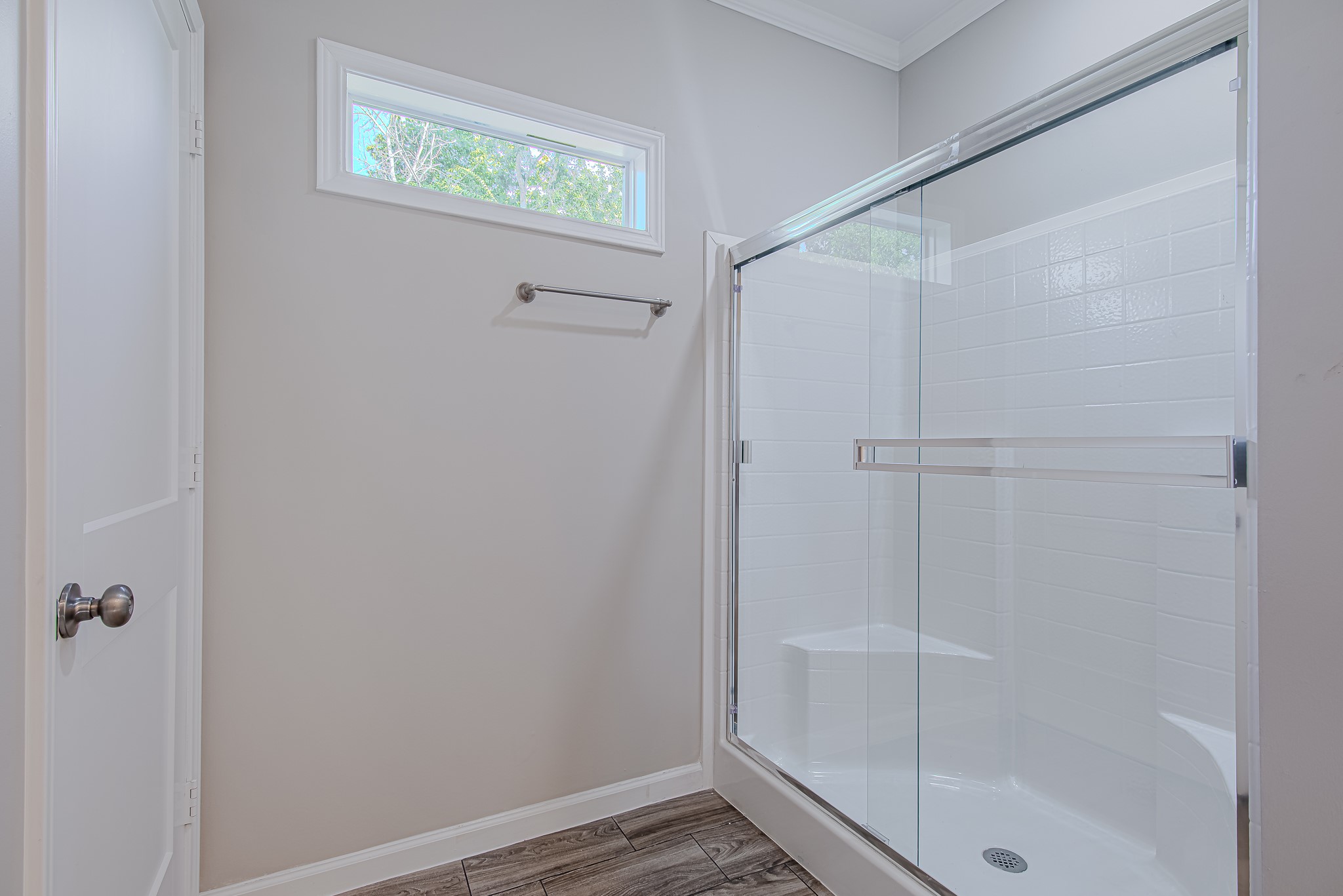 778 Pickering Street Houston, TX 77091 - Photo 17 of 26 Primary bathroom walk-in shower with sleek tile surround and glass door