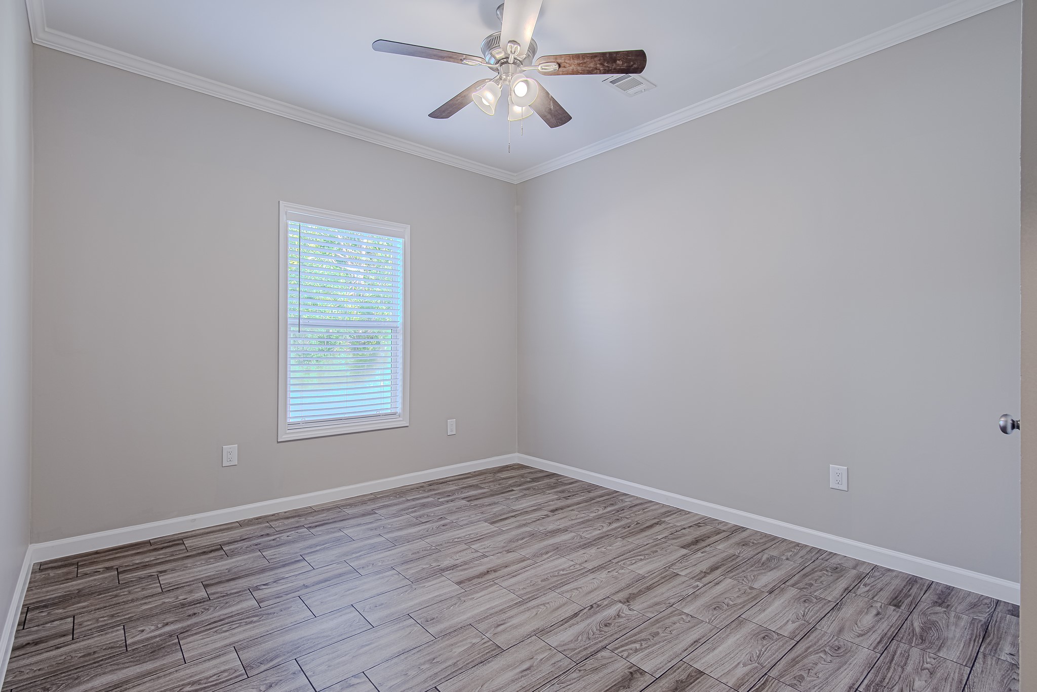 778 Pickering Street Houston, TX 77091 - Photo 21 of 26 Secondary bedroom with neutral finishes, ceiling fan, and window views
