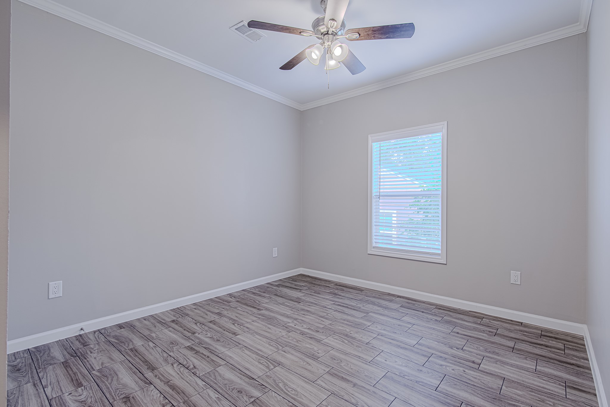 778 Pickering Street Houston, TX 77091 - Photo 23 of 26 Another secondary bedroom with wood-style flooring and ceiling fan