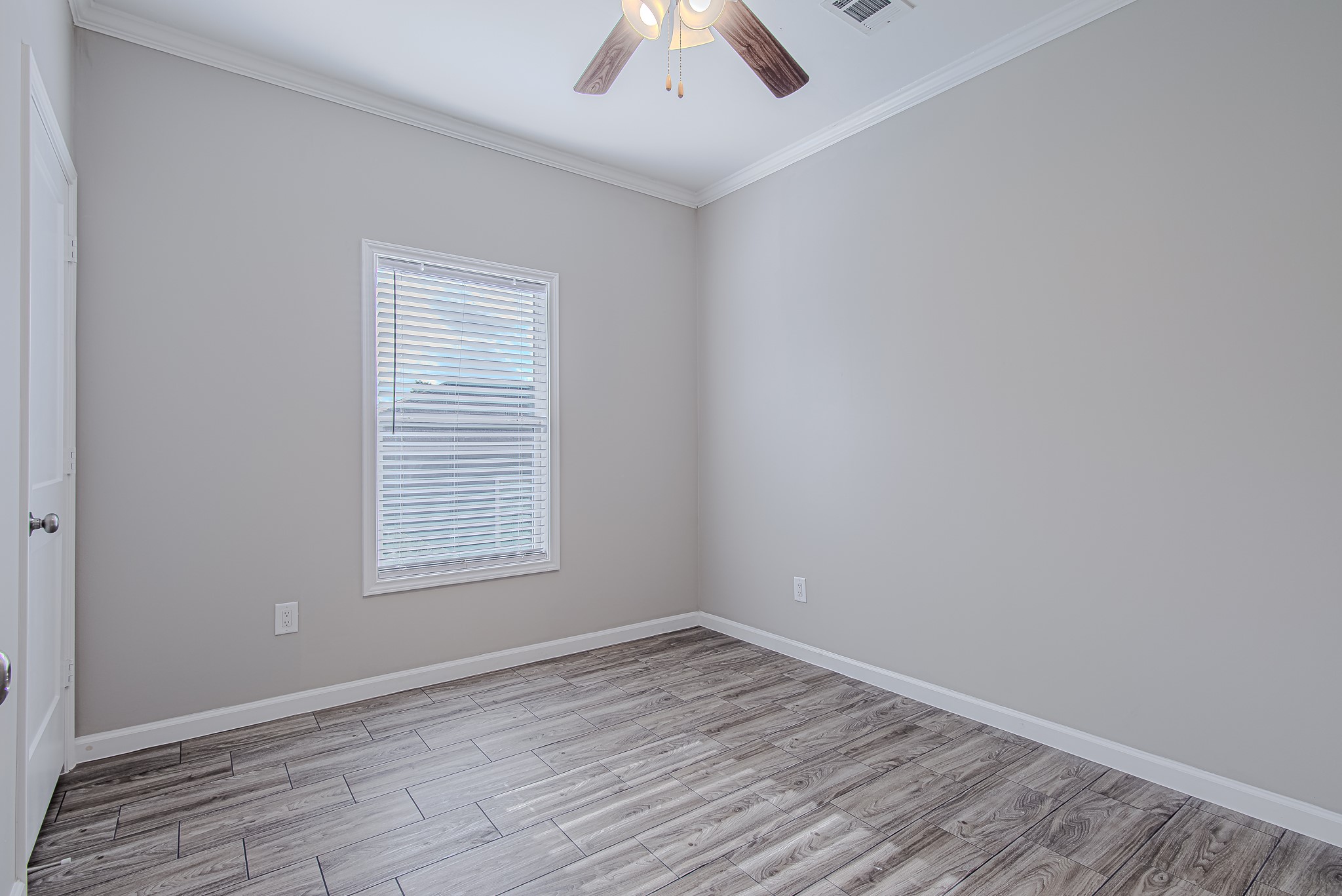 778 Pickering Street Houston, TX 77091 - Photo 25 of 26 Third bedroom featuring vaulted ceiling details, a fan, and bright natural light