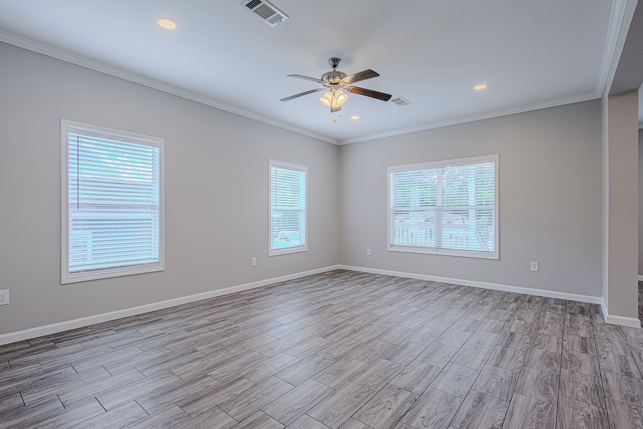 778 Pickering Street Houston, TX 77091 - Photo 8 of 26 Spacious living room with a ceiling fan and multiple windows for abundant light