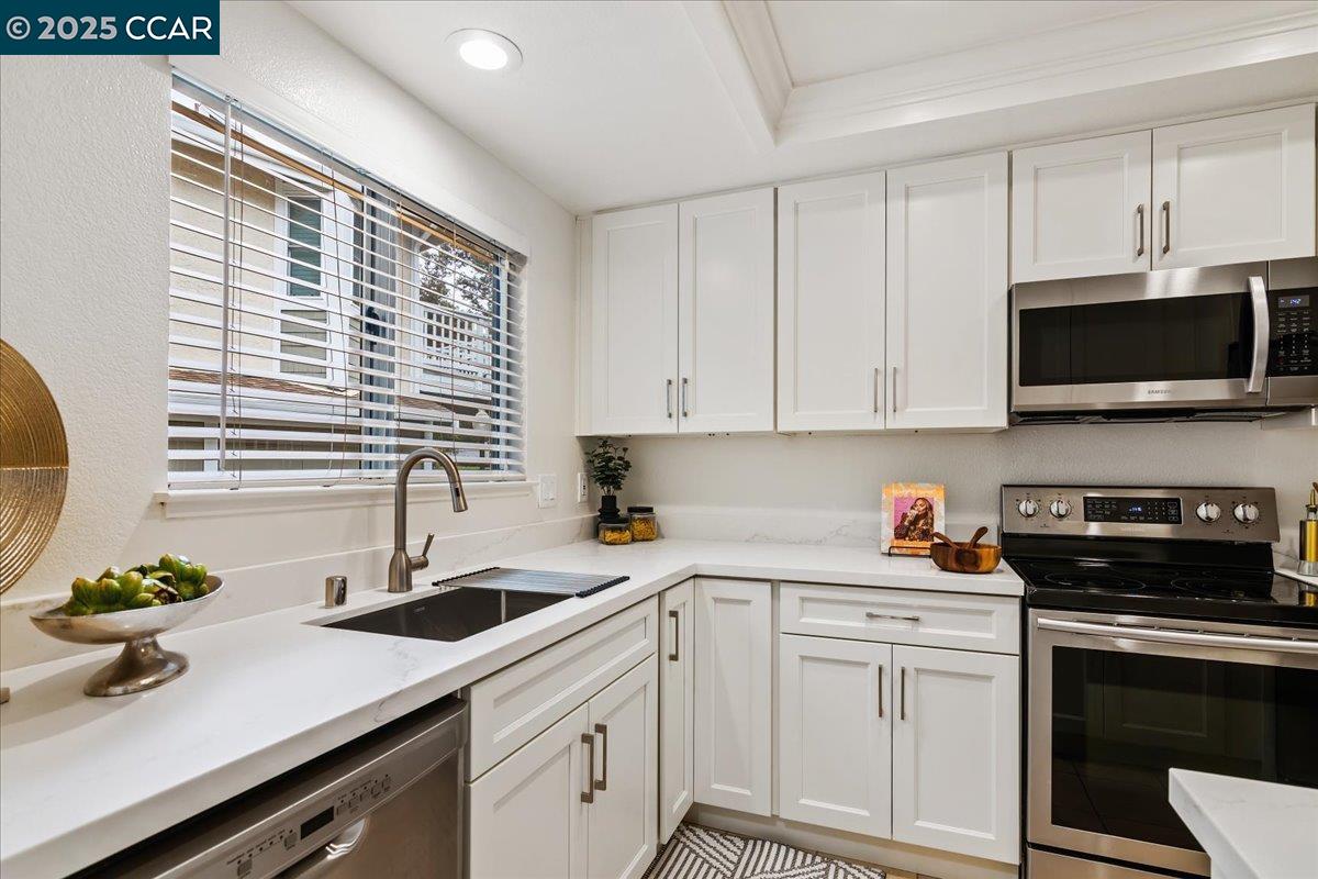 2606 Jones Road, Unit B Walnut Creek, CA 94597 - Photo 5 of 29 a kitchen with stainless steel appliances white cabinets a sink and a stove