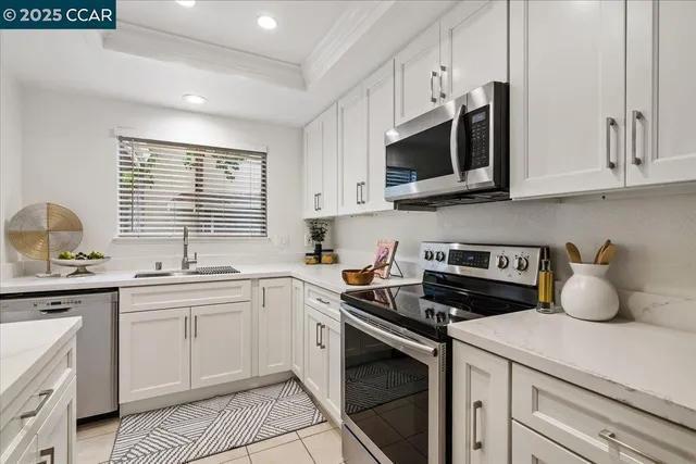 a kitchen with stainless steel appliances a sink stove and microwave