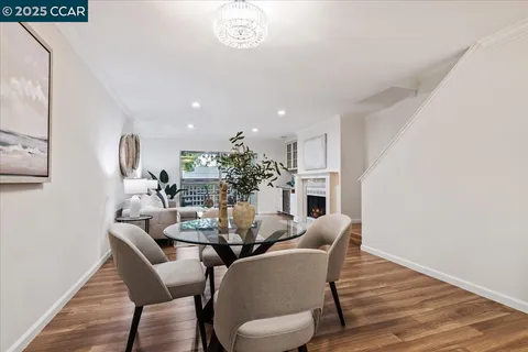 a dining room with furniture and wooden floor