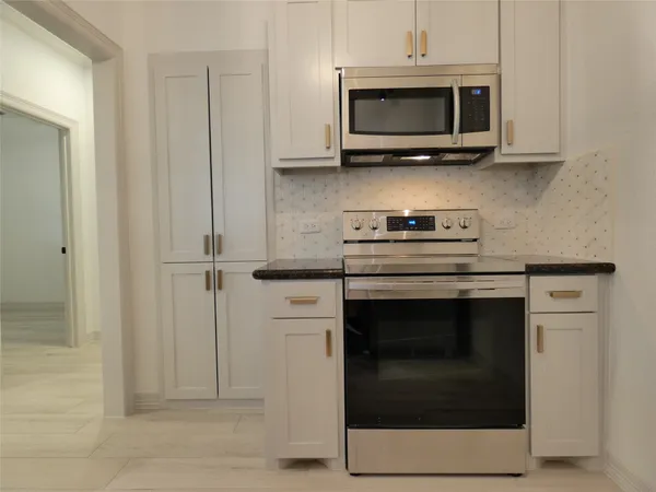 a kitchen with a refrigerator and a sink