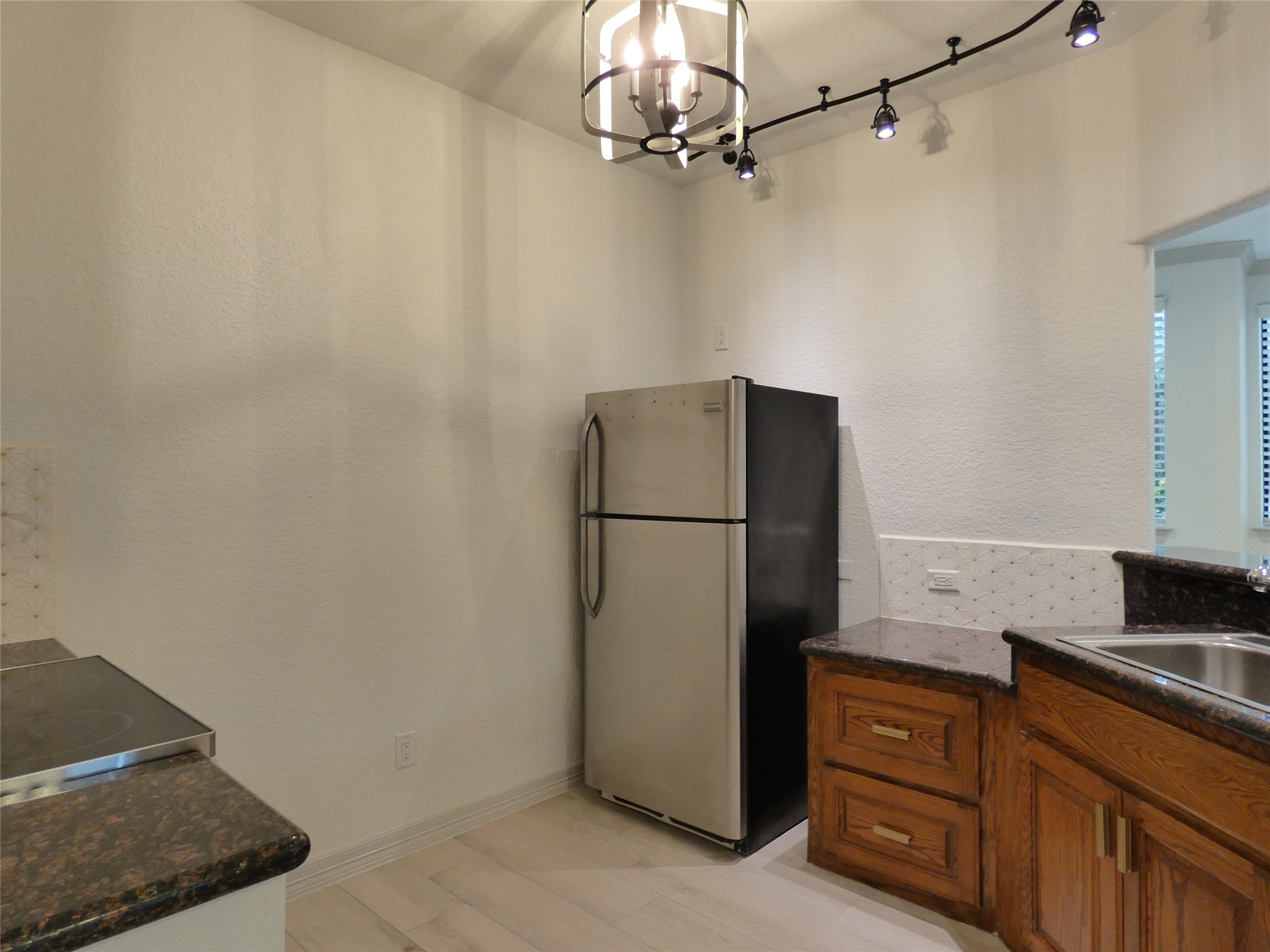 4832 FM 2218 Road, Unit B Rosenberg, TX 77469 - Photo 14 of 33 a kitchen with stainless steel appliances granite countertop a refrigerator and a sink