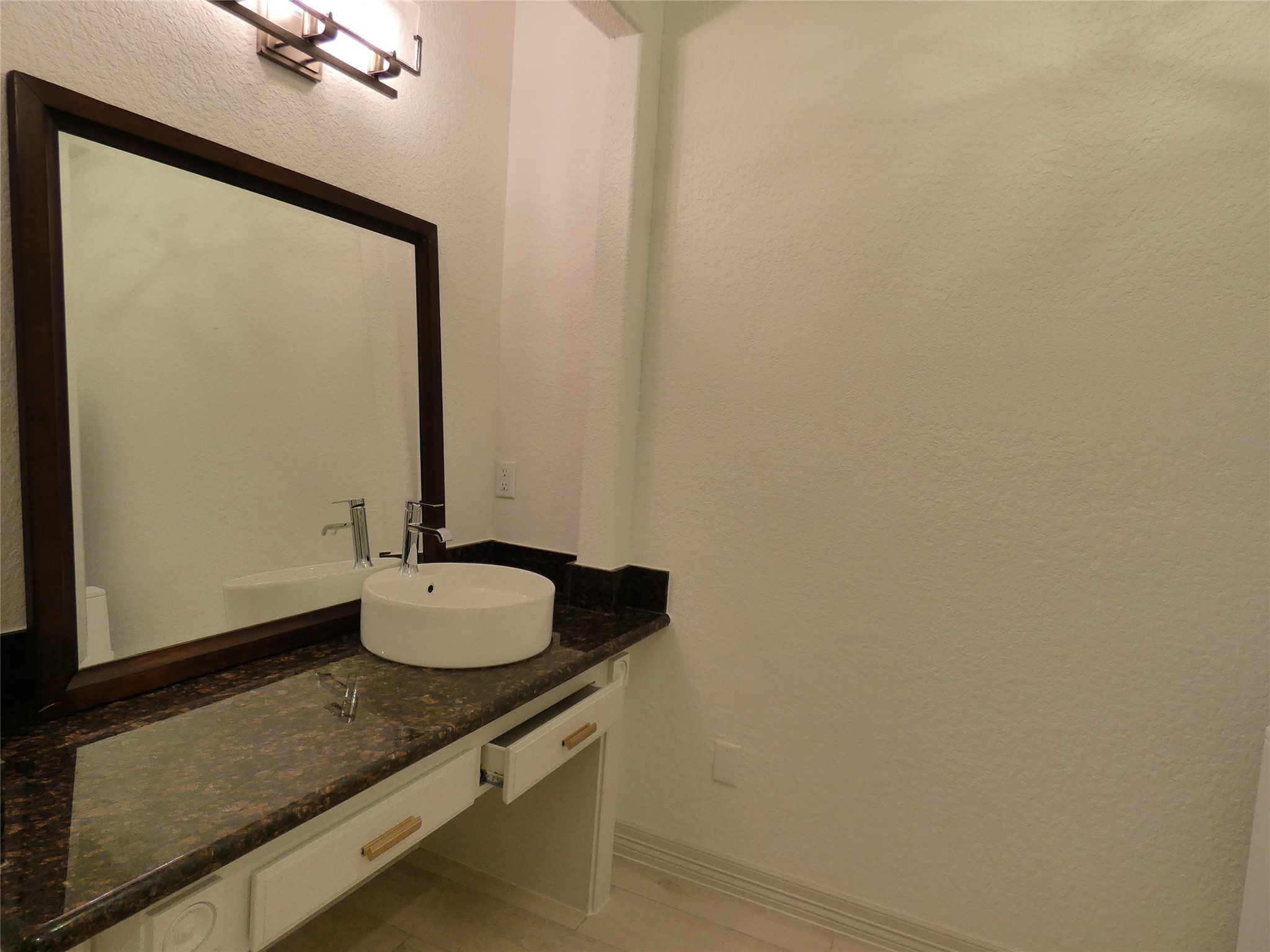 4832 FM 2218 Road, Unit B Rosenberg, TX 77469 - Photo 17 of 33 a bathroom with a granite countertop sink and a mirror