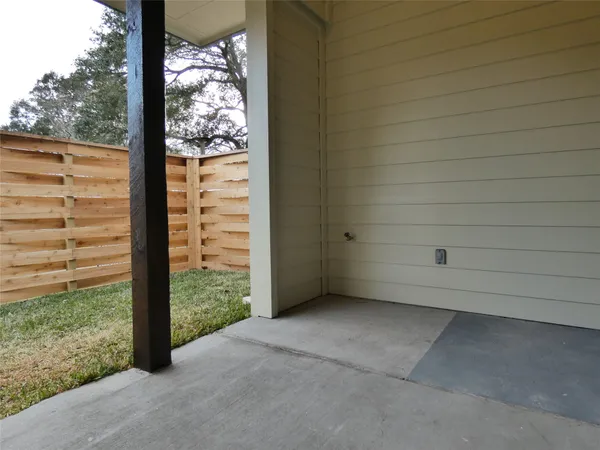 a view of a back yard and a wooden fence