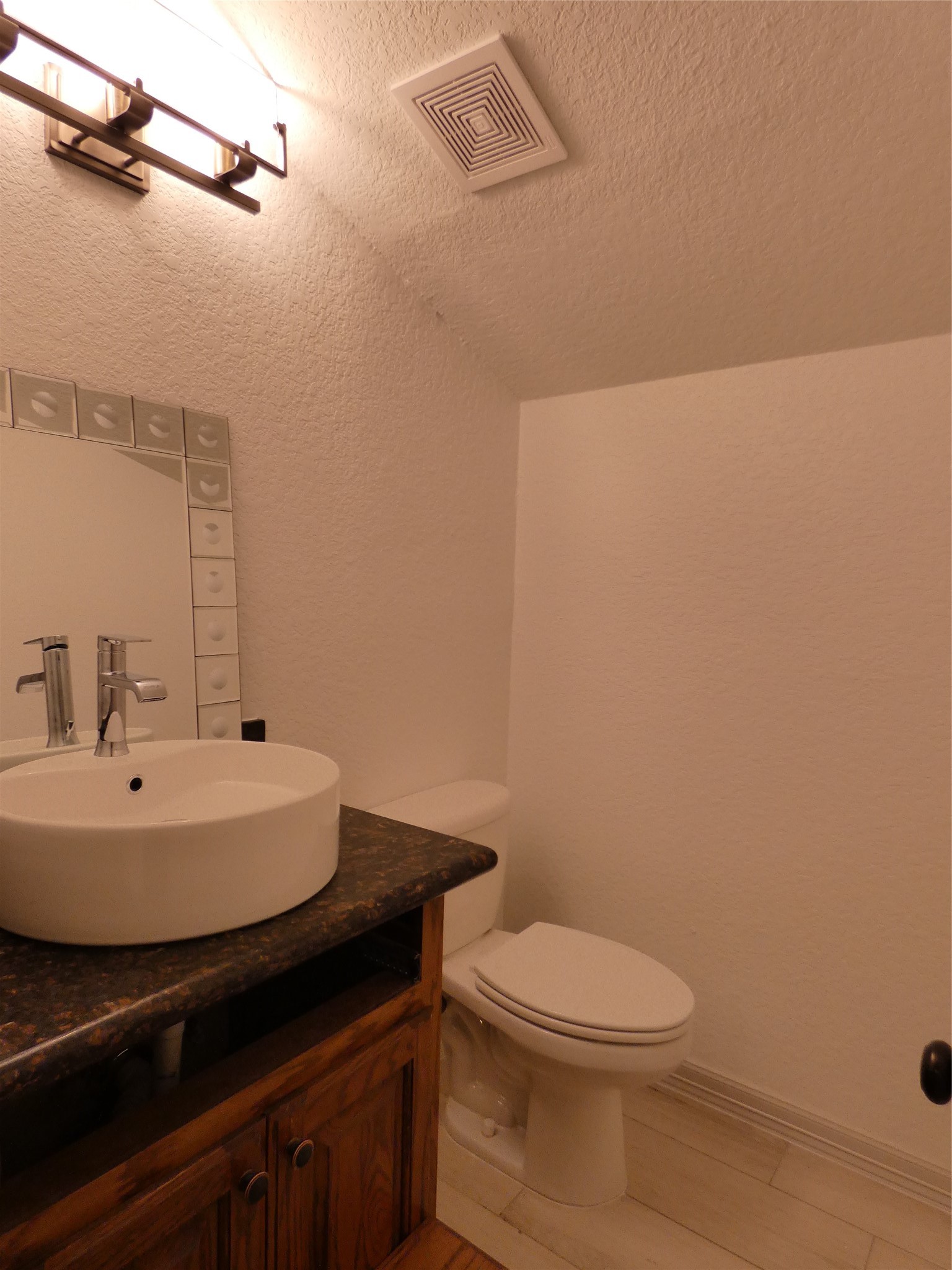 4832 FM 2218 Road, Unit B Rosenberg, TX 77469 - Photo 27 of 33 a bathroom with a sink a toilet and mirror