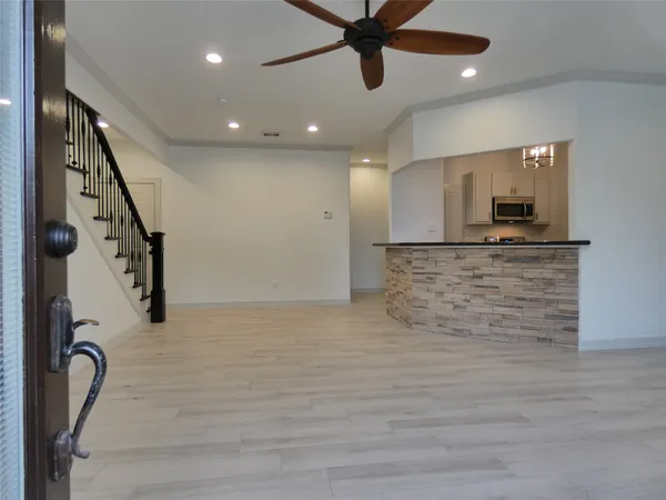 a view of a kitchen with a sink and wooden floor