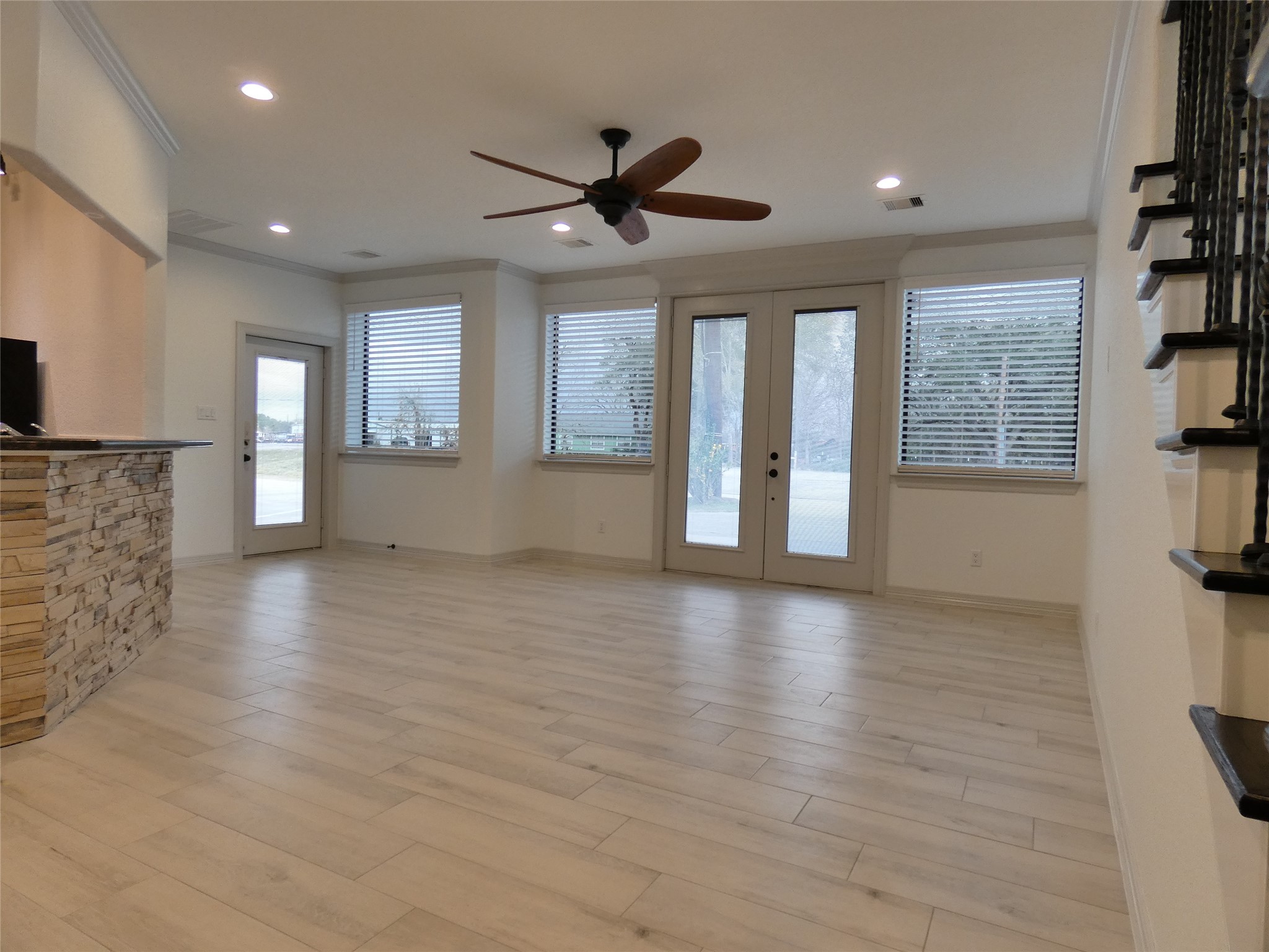 4832 FM 2218 Road, Unit B Rosenberg, TX 77469 - Photo 8 of 33 a view of an empty room with a window and wooden floor