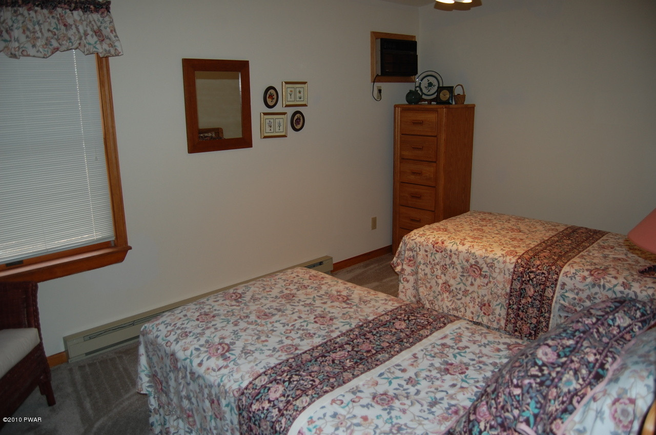 140 Rodeo Drive Hawley, PA 18428 - Photo 8 of 9 a bedroom with a bed and a closet