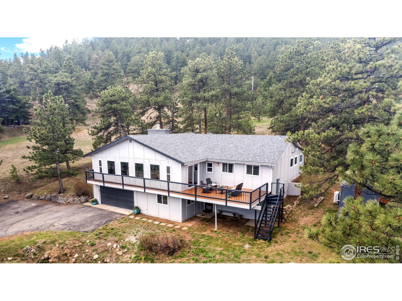 a aerial view of a house with a big yard and large trees