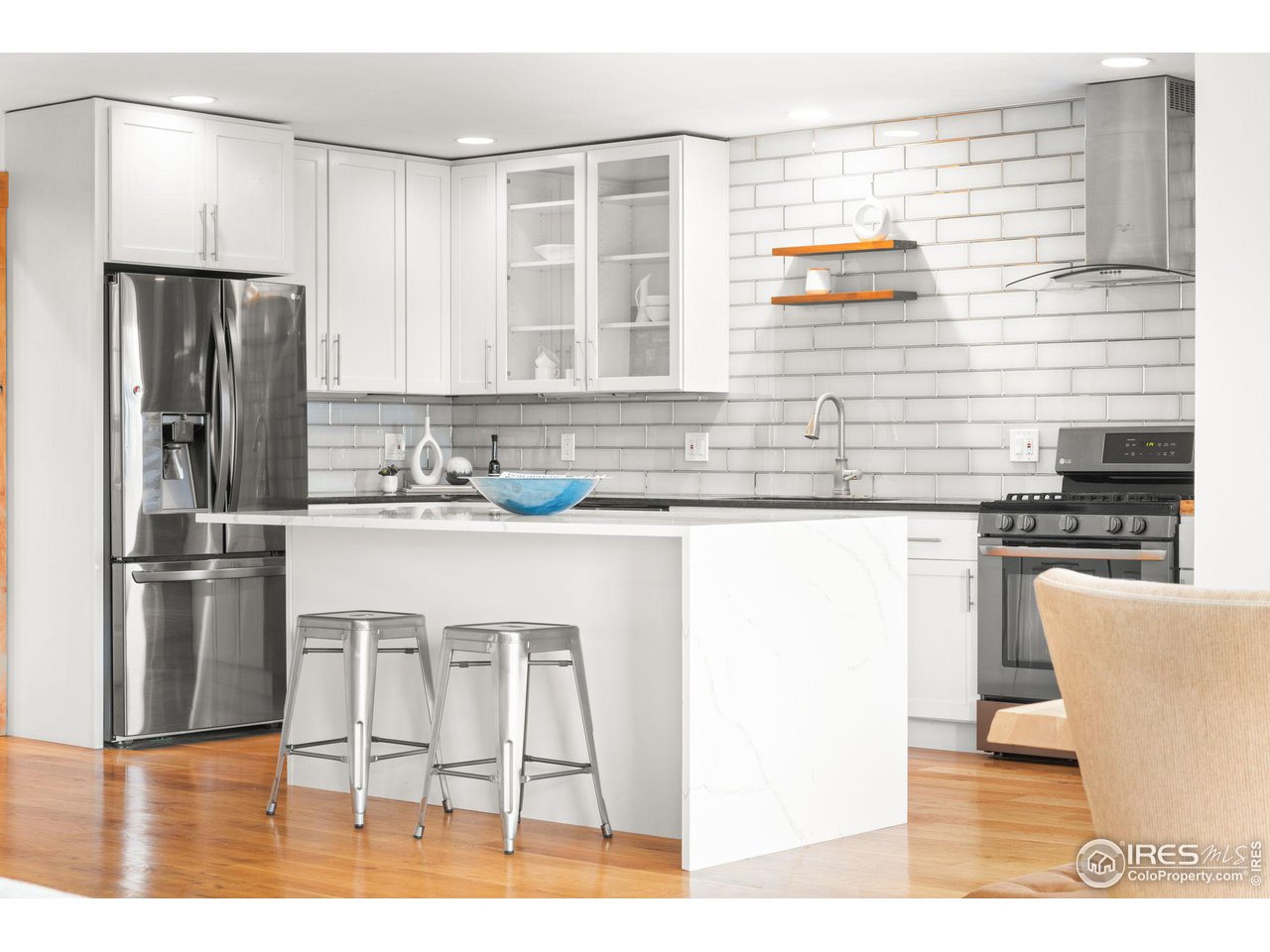 801 Kelly Road West Boulder, CO 80302 - Photo 13 of 33 a kitchen with stainless steel appliances granite countertop a refrigerator a stove and white cabinets with wooden floor