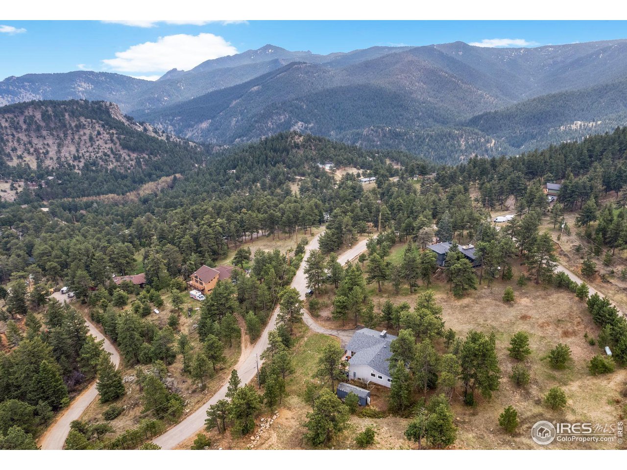 801 Kelly Road West Boulder, CO 80302 - Photo 2 of 33 a view of a house with a mountain in the background