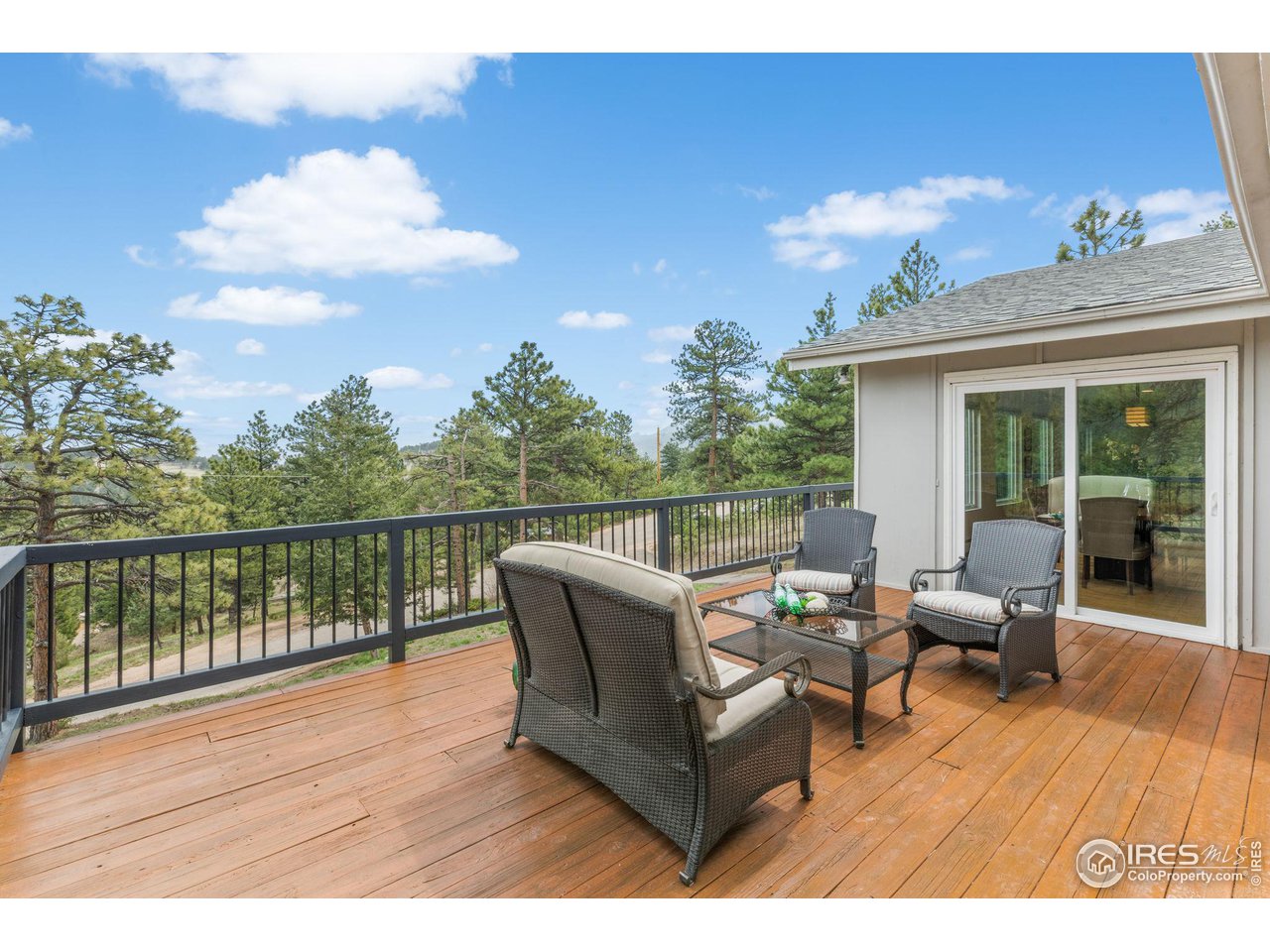 801 Kelly Road West Boulder, CO 80302 - Photo 10 of 33 a balcony with furniture and wooden floor