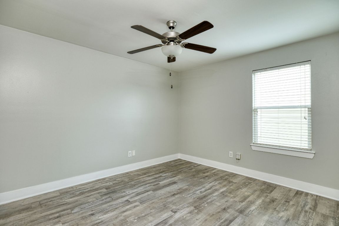 605 Pecan Avenue, Unit 3 Round Rock, TX 78664 - Photo 11 of 15 Unfurnished room featuring light wood-style floors and a ceiling fan