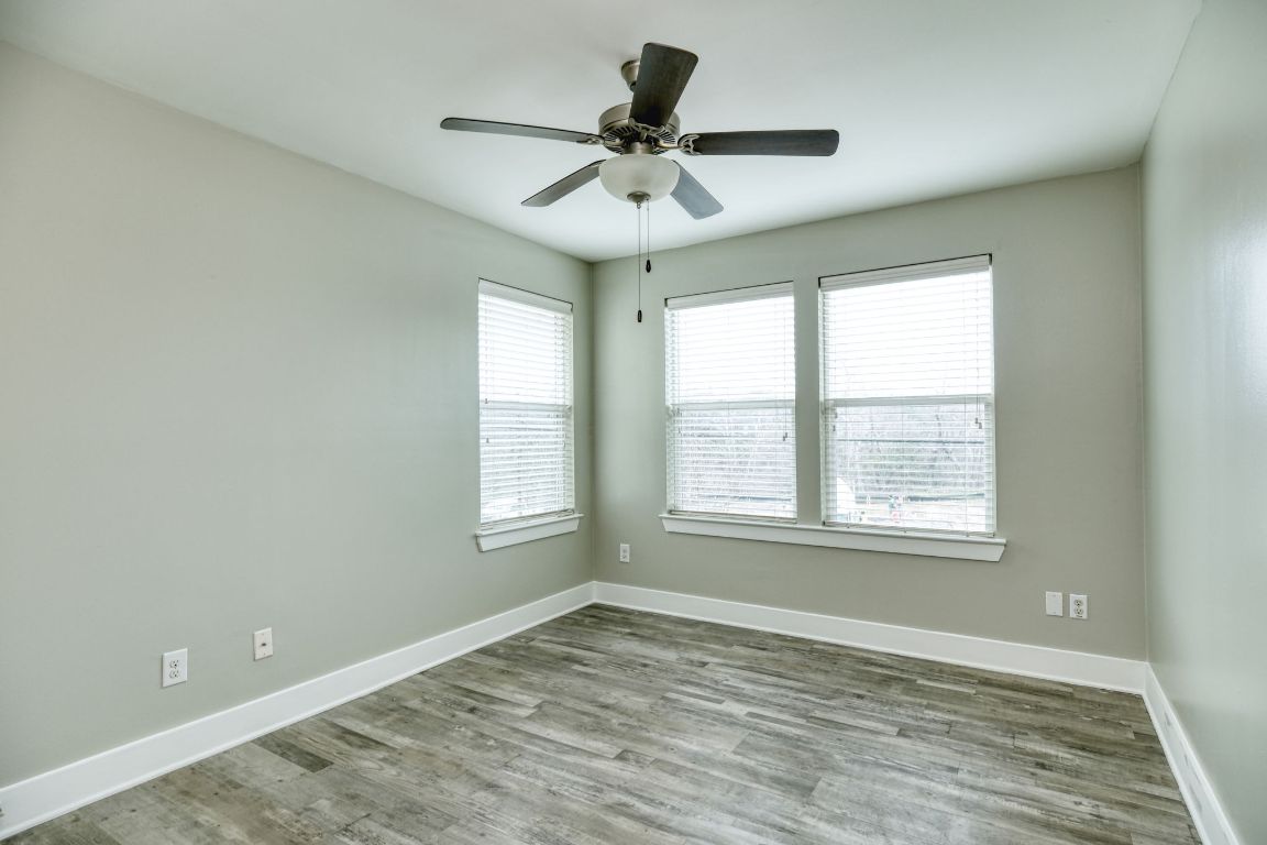 605 Pecan Avenue, Unit 3 Round Rock, TX 78664 - Photo 8 of 15 Spare room with wood finished floors and a ceiling fan