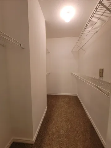 a view of a hallway with closet