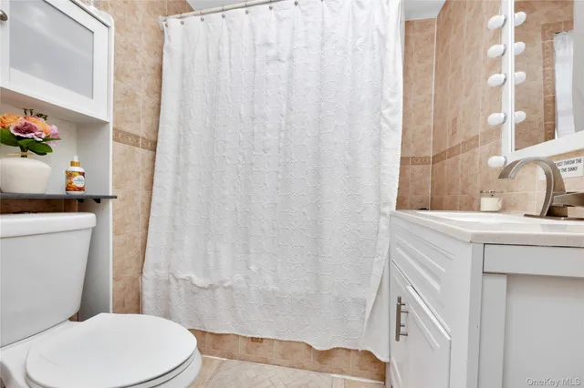 a white toilet sitting next to a bathroom sink