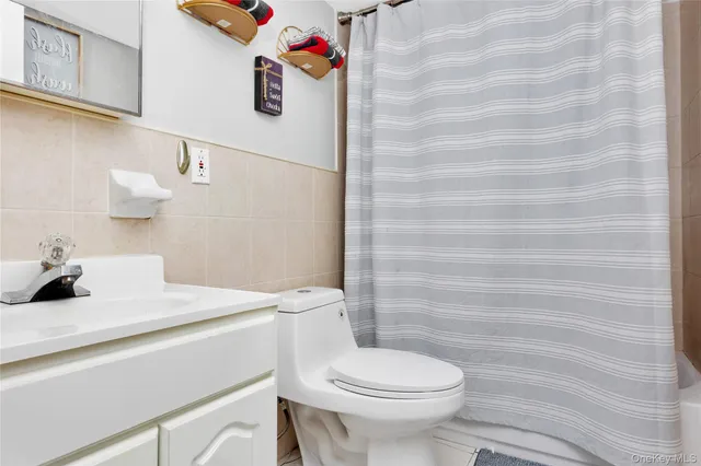 a bathroom with a sink a toilet and a shower curtain