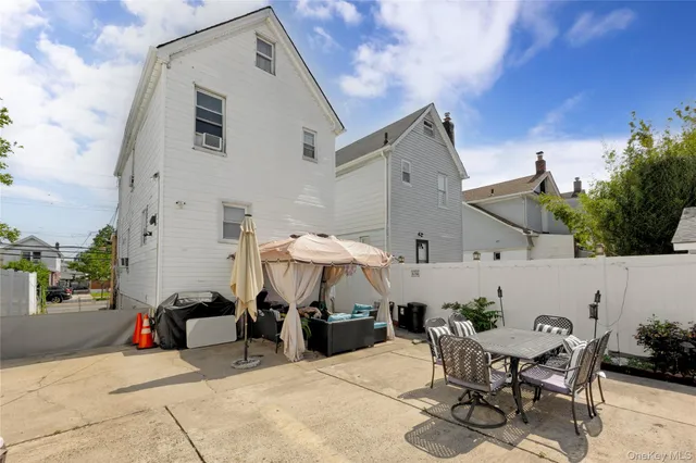 a view of a patio with table and chairs and potted plants